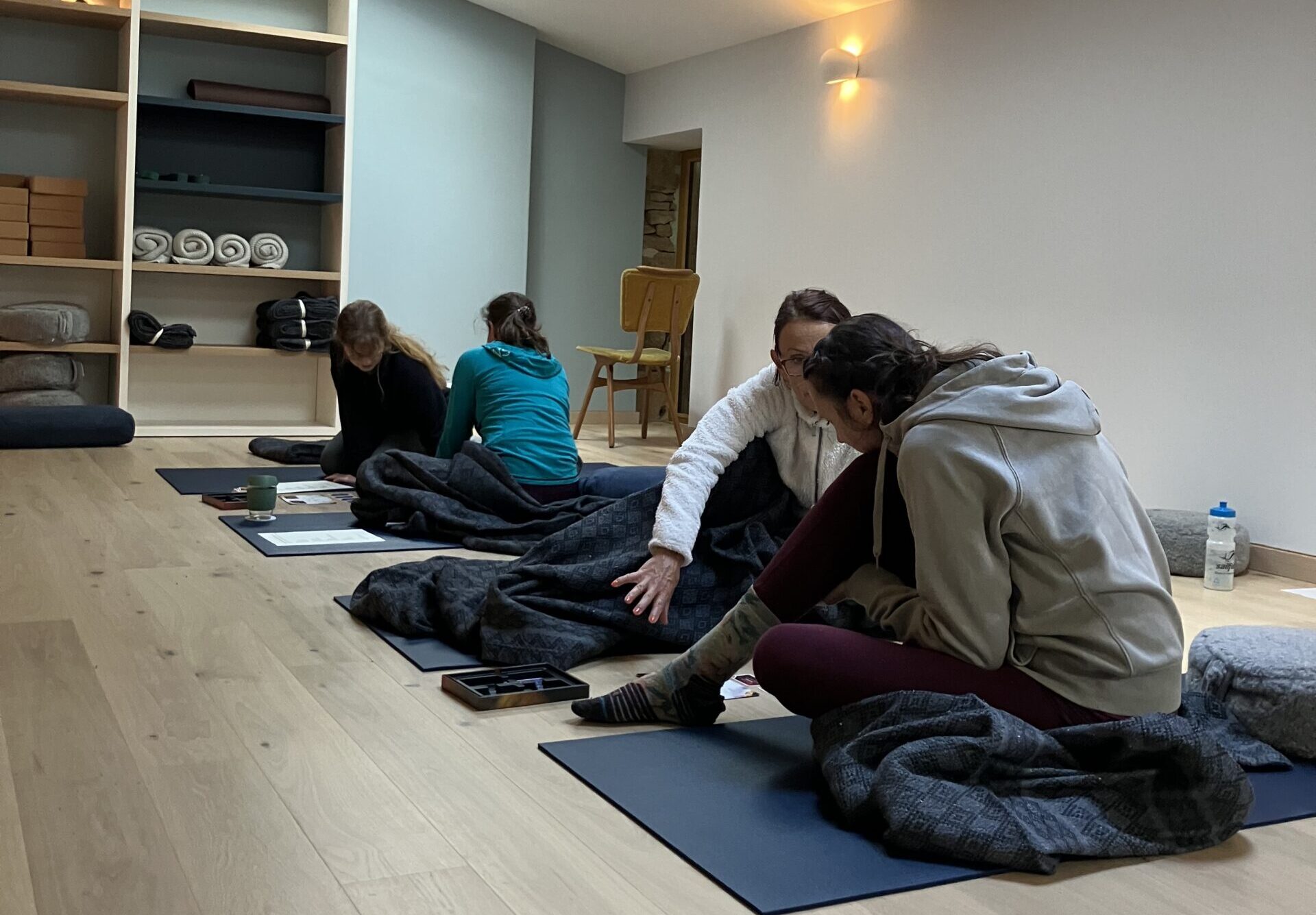 people in a studio working on a project in pairs